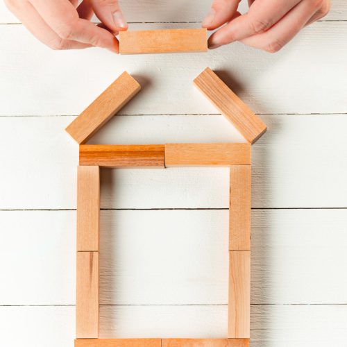 Man and wooden cubes on table. Management and marketing concepts
