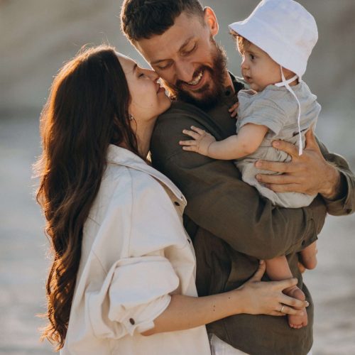Young family with little son on the sunset